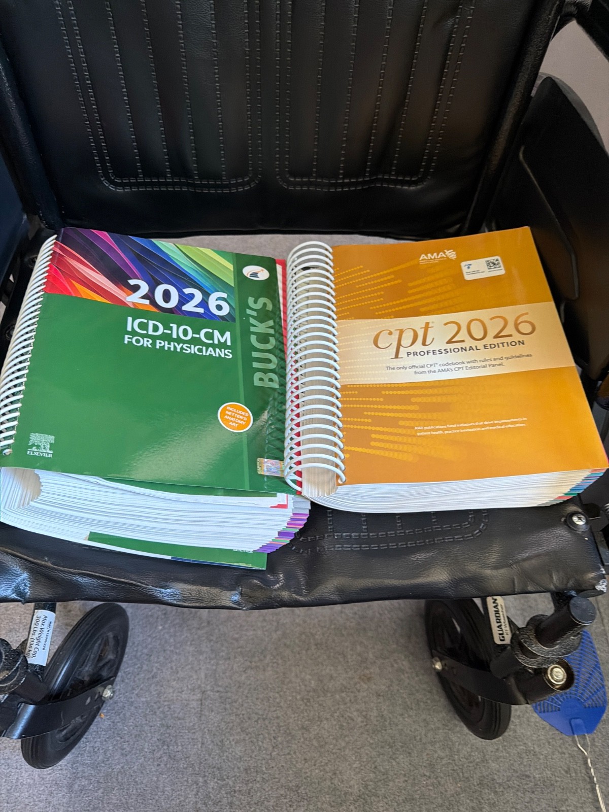 2026 ICD 10 CM box edition coding book along with CPT 2026 professional edition